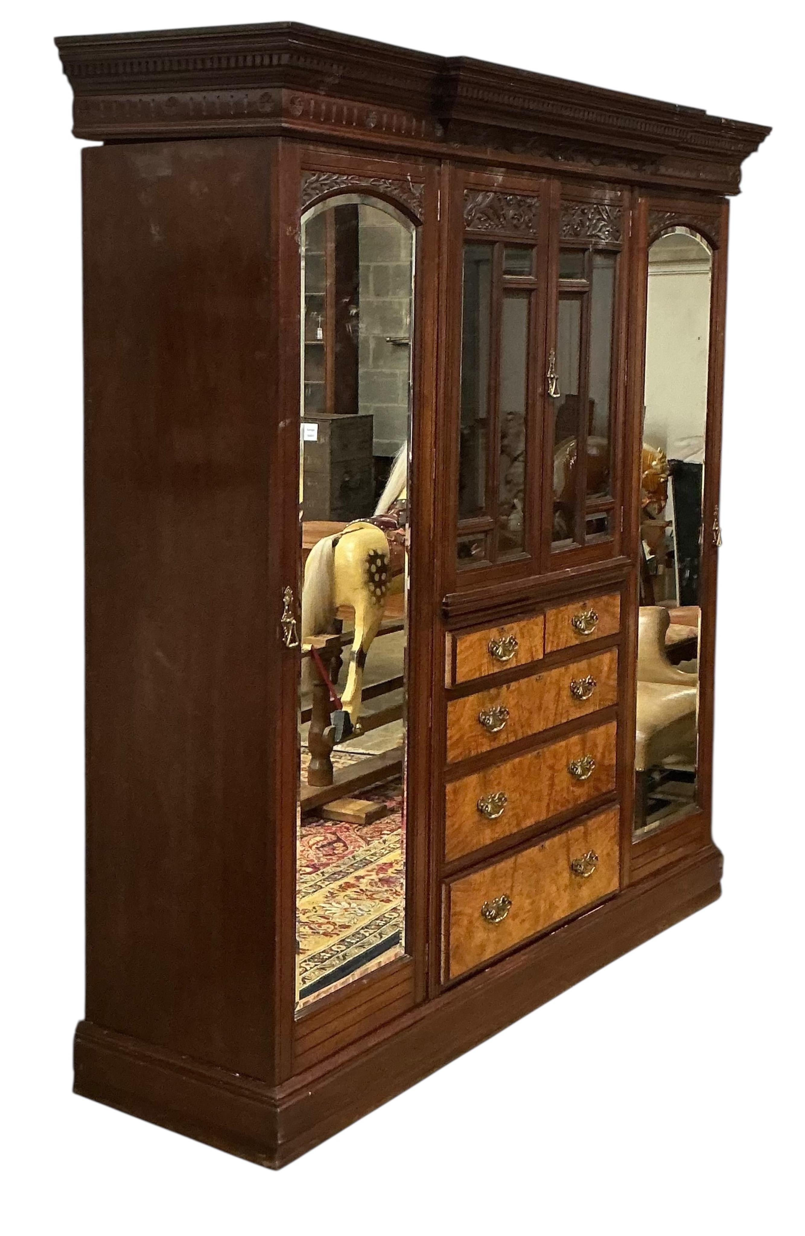A late Victorian carved mahogany mirrored wardrobe, width 208cm, depth 60cm, height 218cm